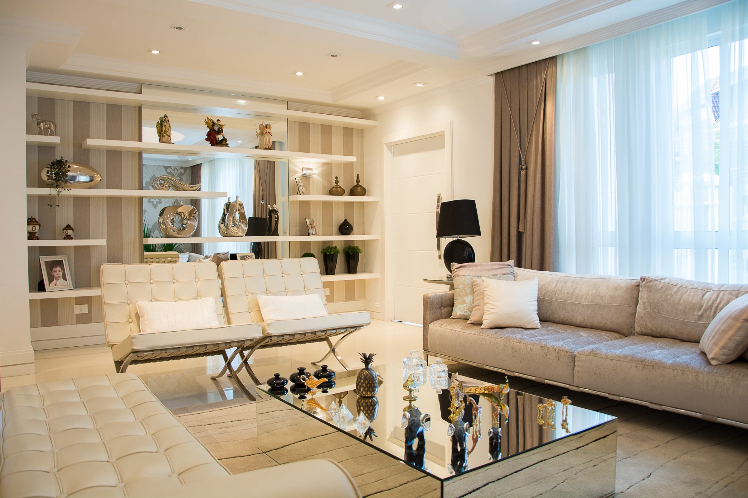 Clean and organized modern living room with neutral decor, minimal furniture, and clutter-free design