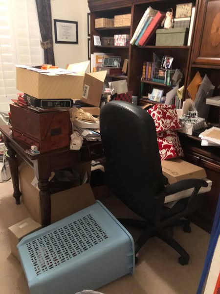 Before image of a cluttered office workspace showing disorganized desk, scattered items, paperwork, and inefficient layout prior to professional organization services by Chaos Coordinator AZ.