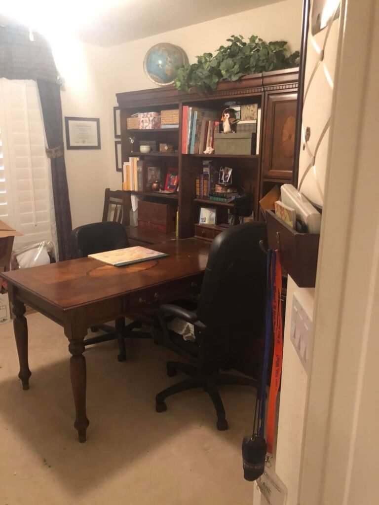 Clean and organized office after professional organization featuring a stylish wood desk, decluttered surfaces, improved storage, and a functional workspace setup by Chaos Coordinator AZ.